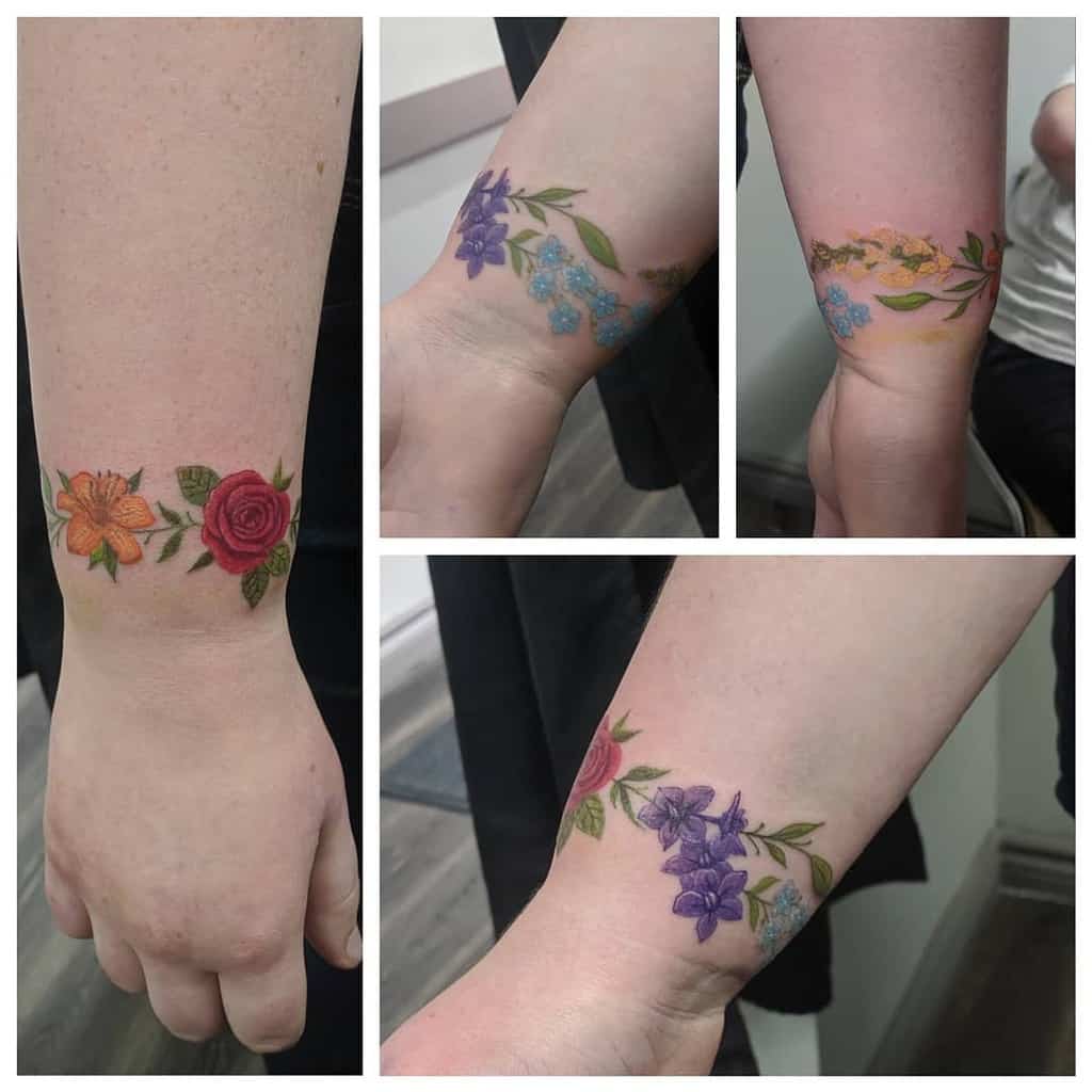 A collage of floral tattoos graces the person's arms, with roses and various flowers in different colors cascading down to the wrist