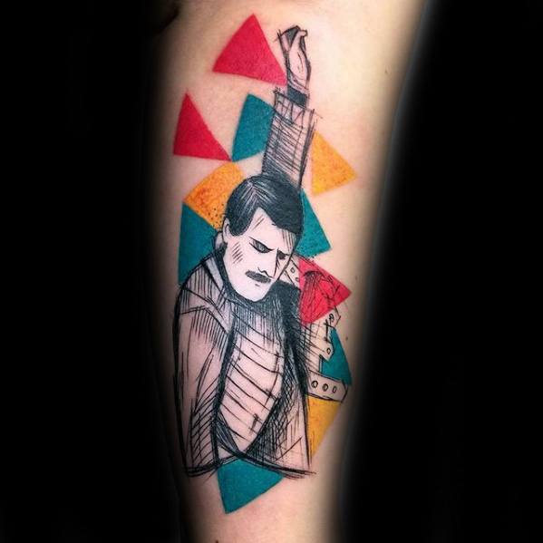 Sketch-style Freddie Mercury tattoo with colorful geometric shapes, showing his iconic fist-raised pose in a minimal line-art design.
