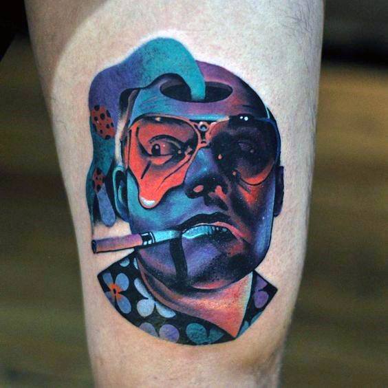 Hunter S. Thompson tattoo with a surreal, colorful portrait featuring aviator glasses, a cigarette, and a melting, psychedelic effect.