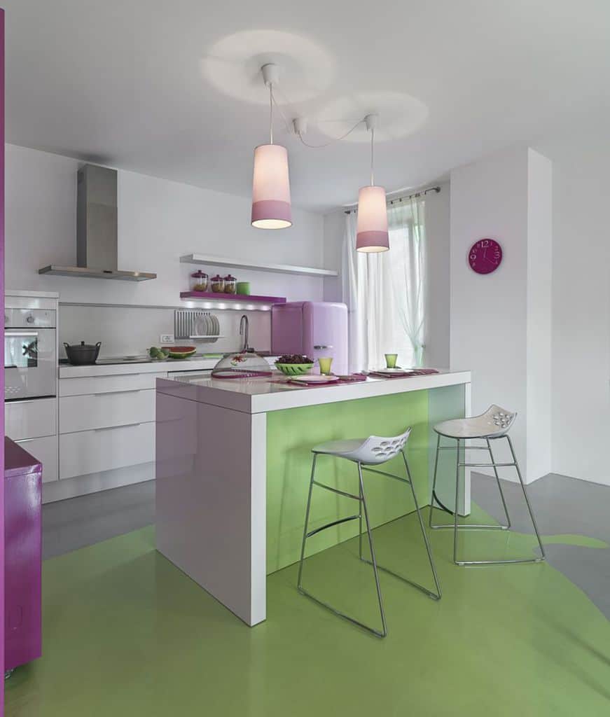 white kitchen with pink accents green island