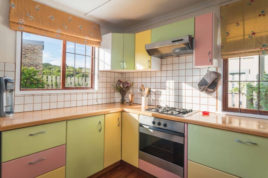 retro kitchen with yellow green and pink cabinets