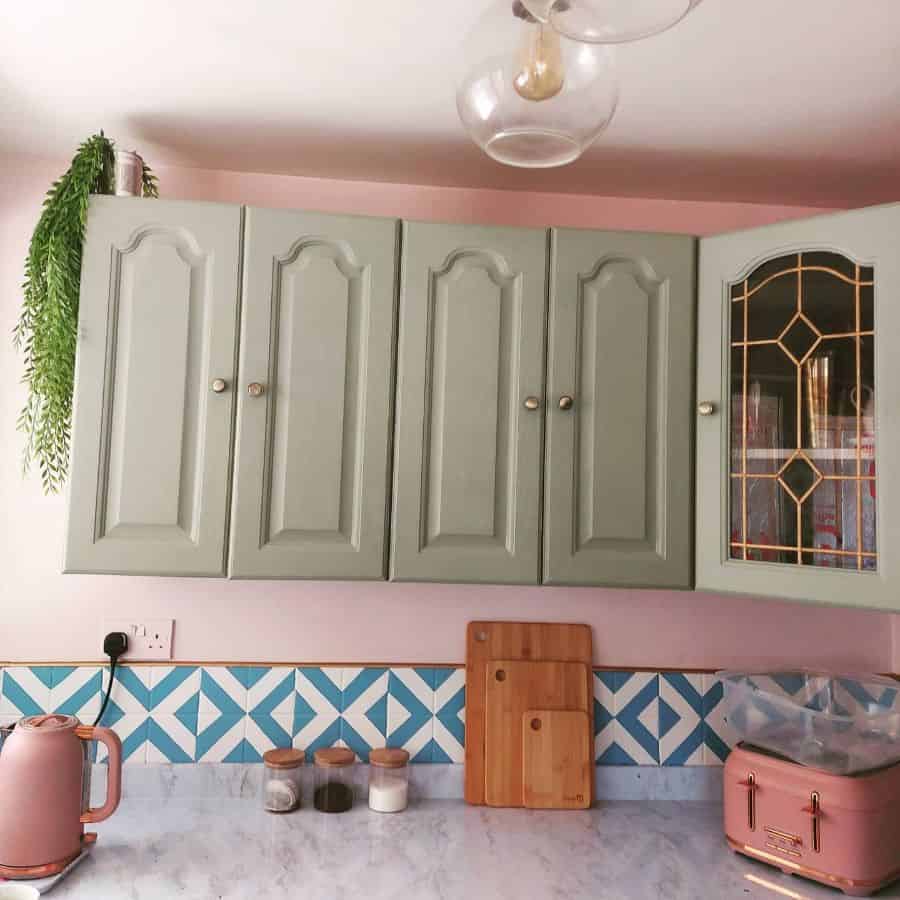 pink wall kitchen with green wall shelves