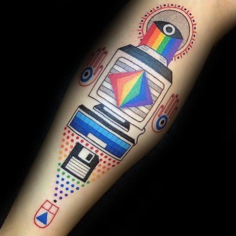 Futuristic tattoo of a stylized computer with rainbow elements, geometric shapes, floppy disk, and vibrant digital-inspired design.