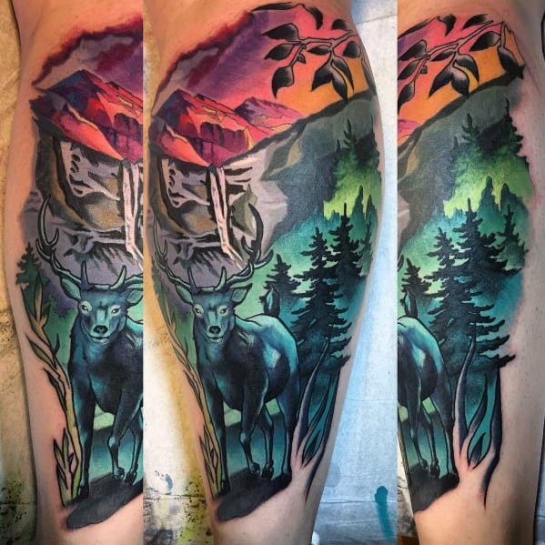 Vibrant elk tattoo with a colorful mountain landscape, featuring rich blues, greens, and warm sunset hues for a bold and scenic design.
