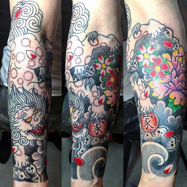 Colorful tattoo of a dragon and flowers on a forearm