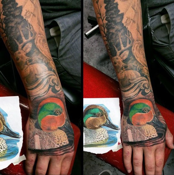 Colorful Orange And Green Duck Tattoo On Mans Hand