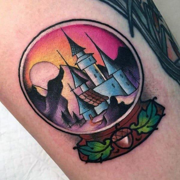 Colorful Small Castle Snow Globe Tattoo Design On Man
