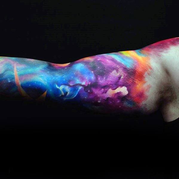 Nebula-themed galaxy tattoo sleeve on a person's arm against a black background