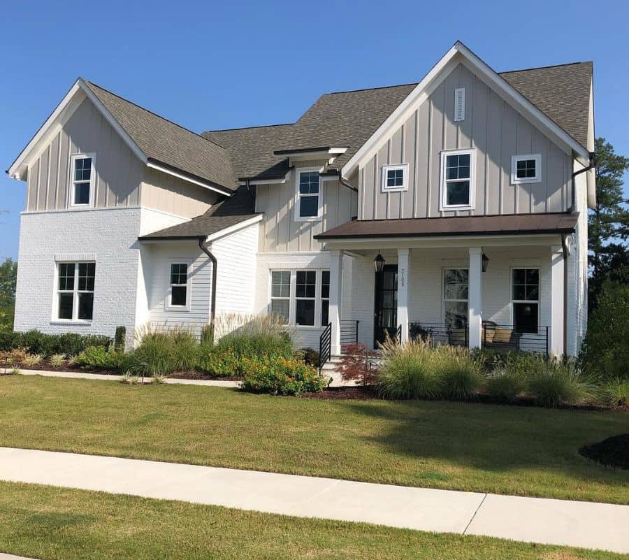 combination white brick and cream siding large house exterior 