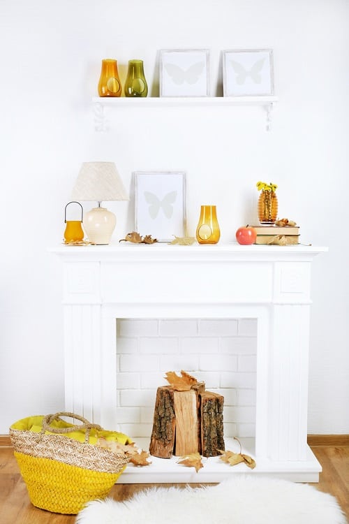 white fireplace and mantel with wall shelf and log decoration