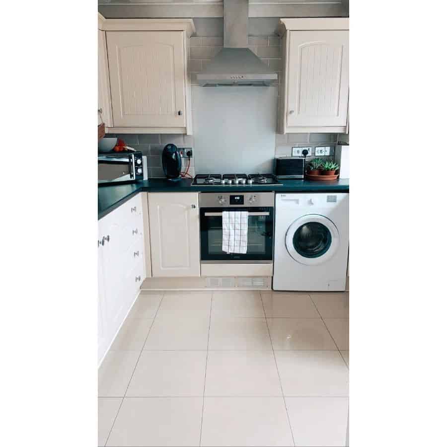 compact kitchenette white cabinets washing machine