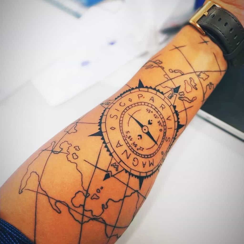Forearm tattoo featuring a compass with 'Sic Parvis Magna' text and detailed map lines for a travel-inspired design