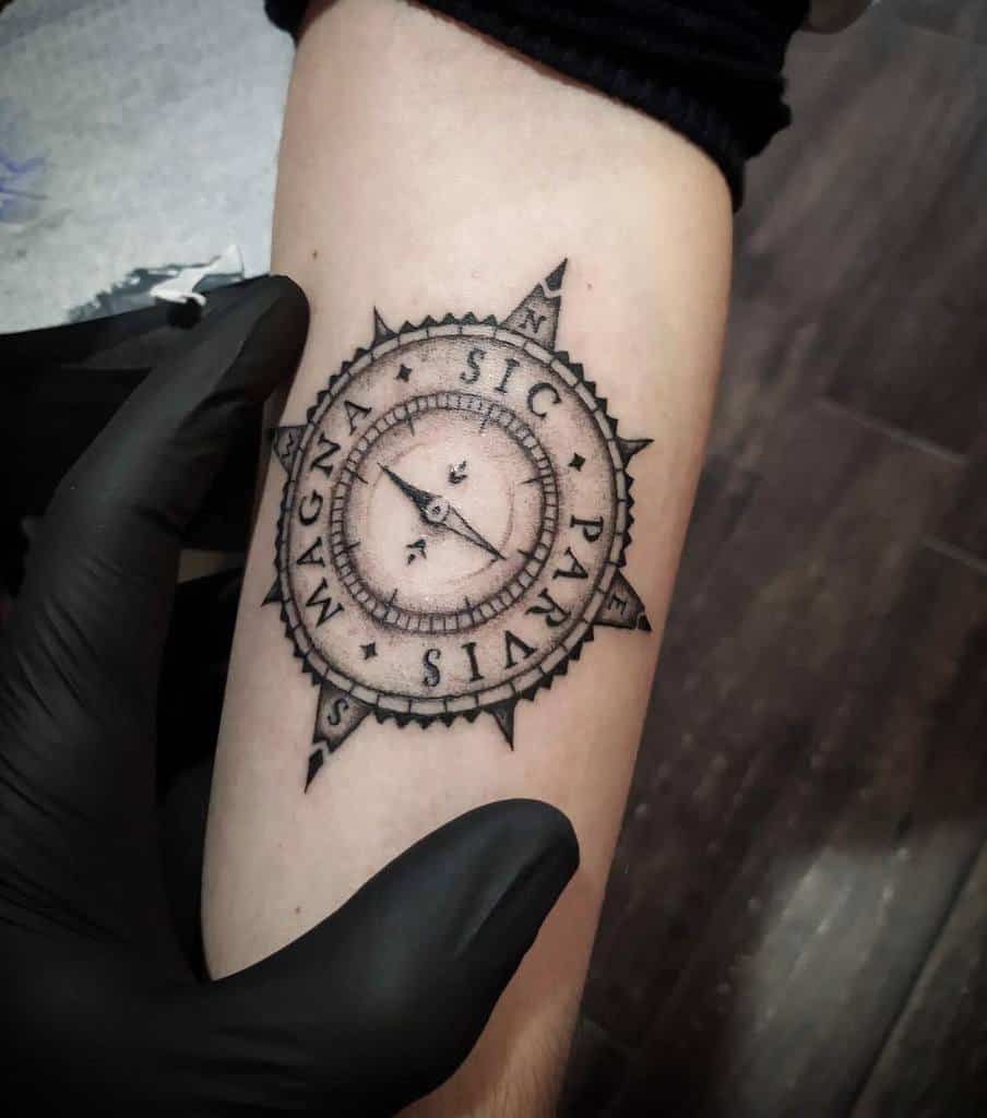 Compass tattoo on forearm with "Sic Parvis Magna" text