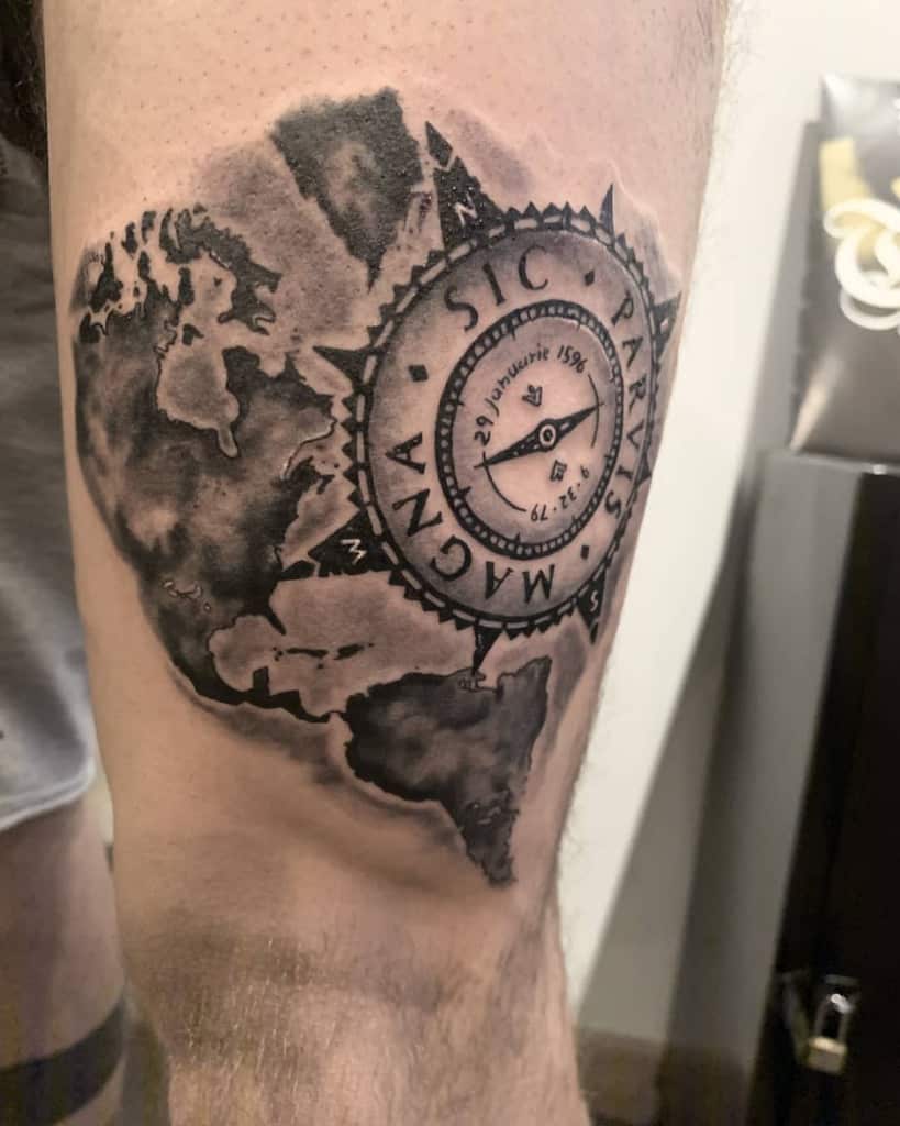 Leg tattoo featuring a shaded world map with a central compass design and 'Sic Parvis Magna' text in a bold blackwork style