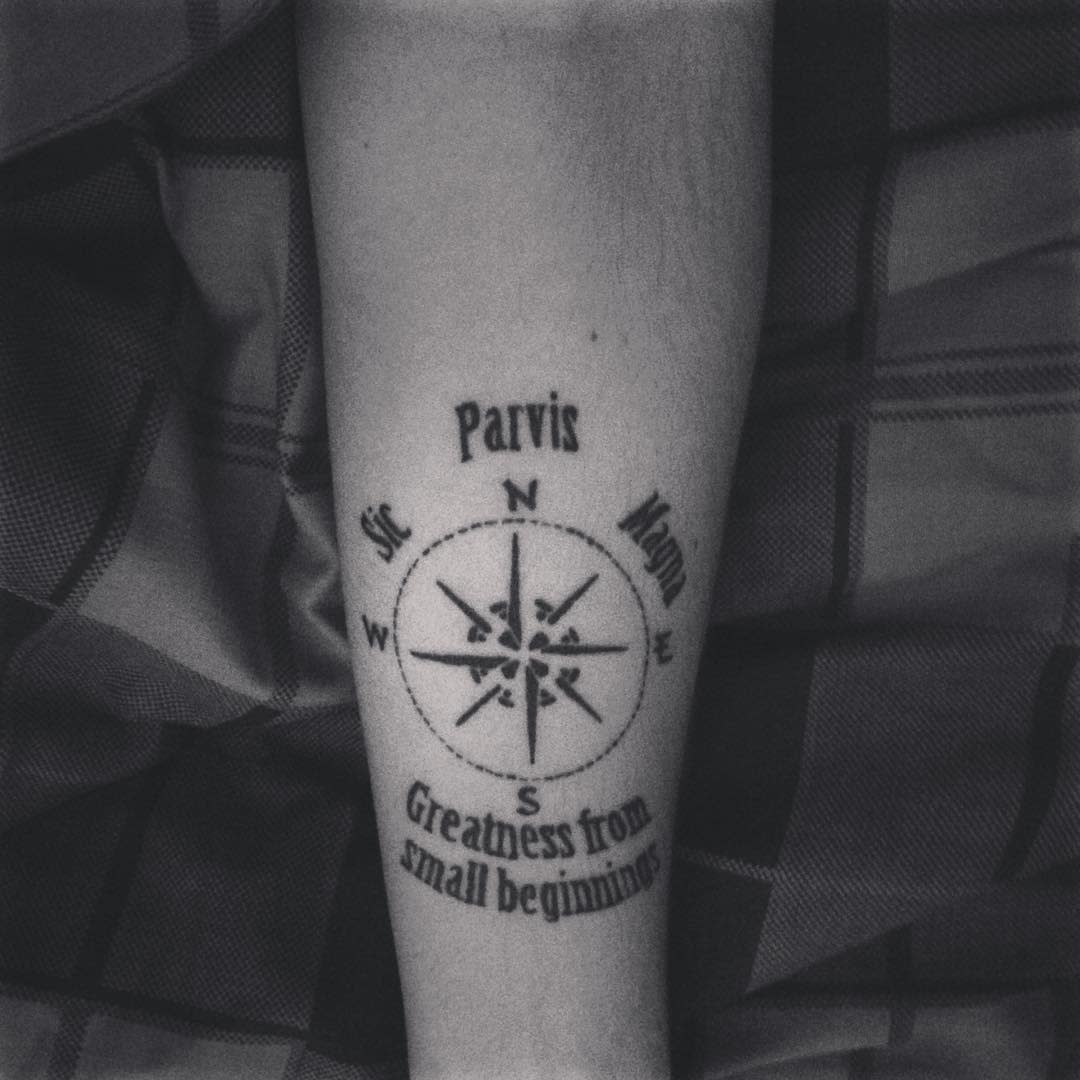 Compass tattoo on forearm with text "Sic Parvis Magna" and "Greatness from small beginnings"
