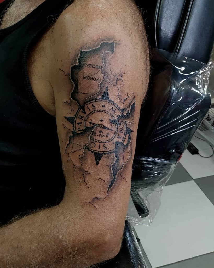 Upper arm tattoo featuring a compass with 'Sic Parvis Magna' text over a torn map design, creating a layered 3D effect