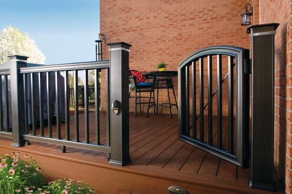 Gate and railing on a wooden deck with patio furniture in the background