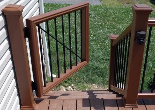 A brown deck gate opens onto a grassy lawn
