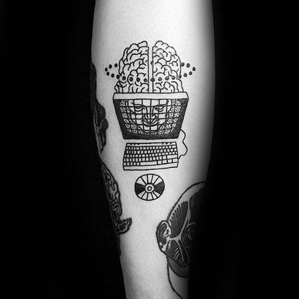 Blackwork tattoo of a brain inside a computer monitor, with a keyboard and CD below, symbolizing the fusion of mind and machine.