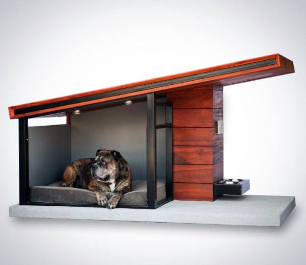 A dog lounges in a sleek, minimalist wooden doghouse with a stylish cantilevered roof