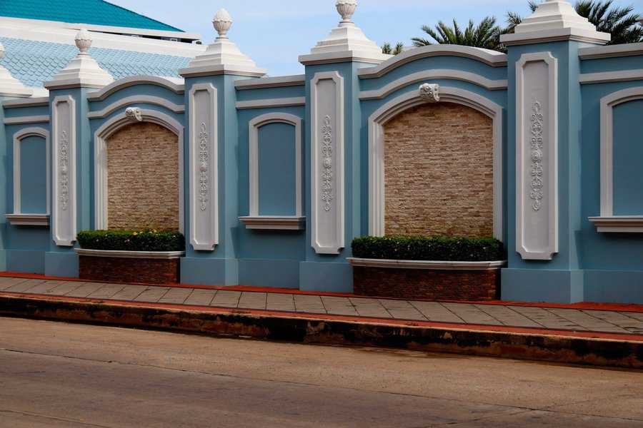 Elegant blue concrete fence with Roman-style columns and decorative accents.