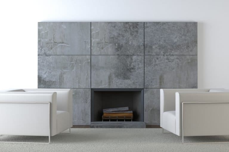 concrete fireplace two white sofa chairs