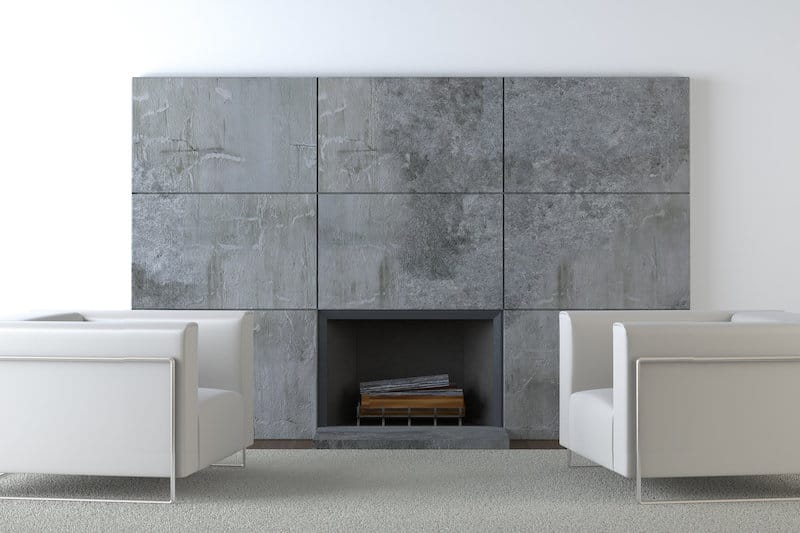 concrete fireplace two white sofa chairs