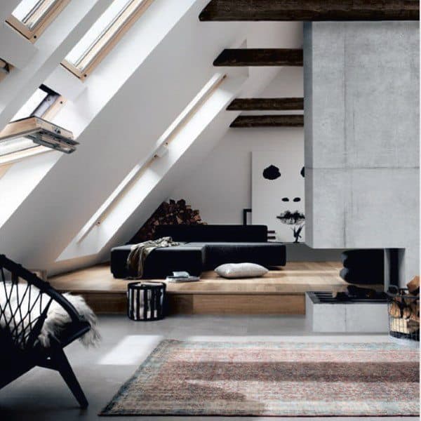 Modern attic living space with a suspended concrete fireplace, wooden beams, and skylights.