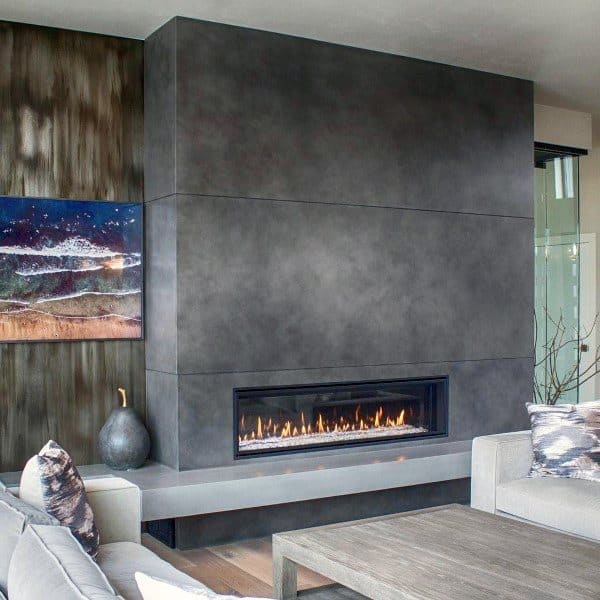 Sleek concrete gas fireplace in a modern living room with abstract wall art.