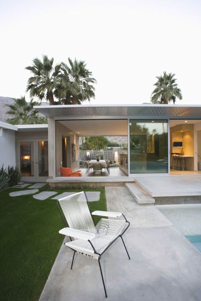 minimalist home with concrete patio and pool deck