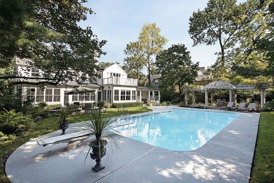 concrete patio pool deck with diving board