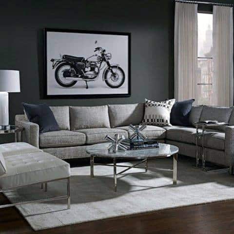 Grey sectional daybed couch in a contemporary living room with a motorcycle wall art and modern decor.
