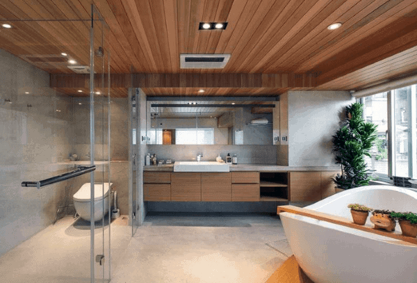 Contemporary bathroom with wood plank ceiling, freestanding tub, glass shower, and floating vanity.