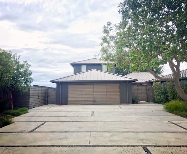 concrete paver driveway with landscaping pebbles