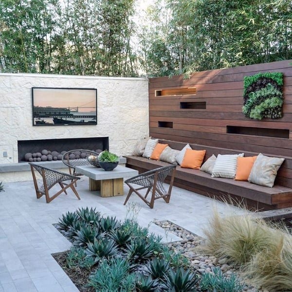 Modern patio with wooden seating, vertical garden, outdoor TV, and minimalist decor.