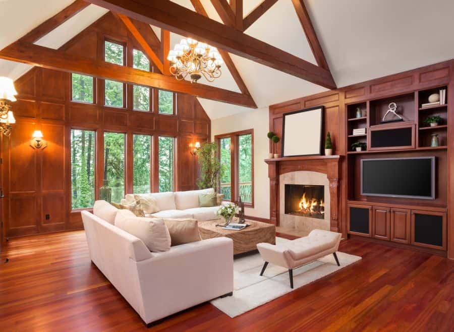 contemporary wood family room high ceiling fireplace white couch hardwood floors