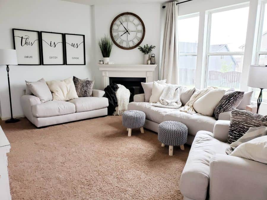 contemporary white family room white sofa framed wall art clock fireplace 