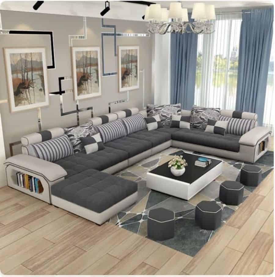 contemporary living room large gray sofa blue curtains abstract wall art 