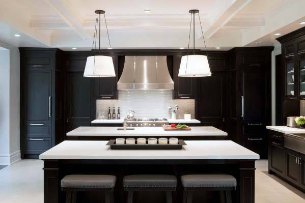 large modern kitchen with two islands and black cabinets