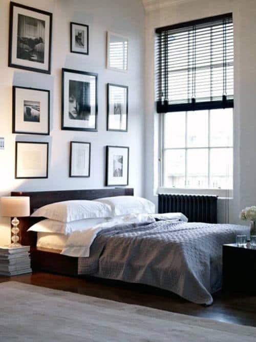 black and white modern bedroom with framed images on wall