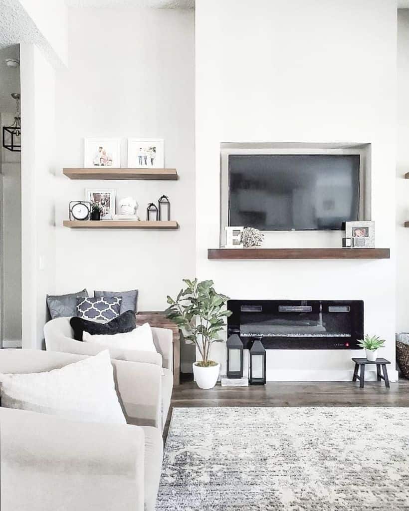 contemporary modern farmhouse living room white lounge chairs electric fireplace recessed tv wood wall shelves gray floor rug