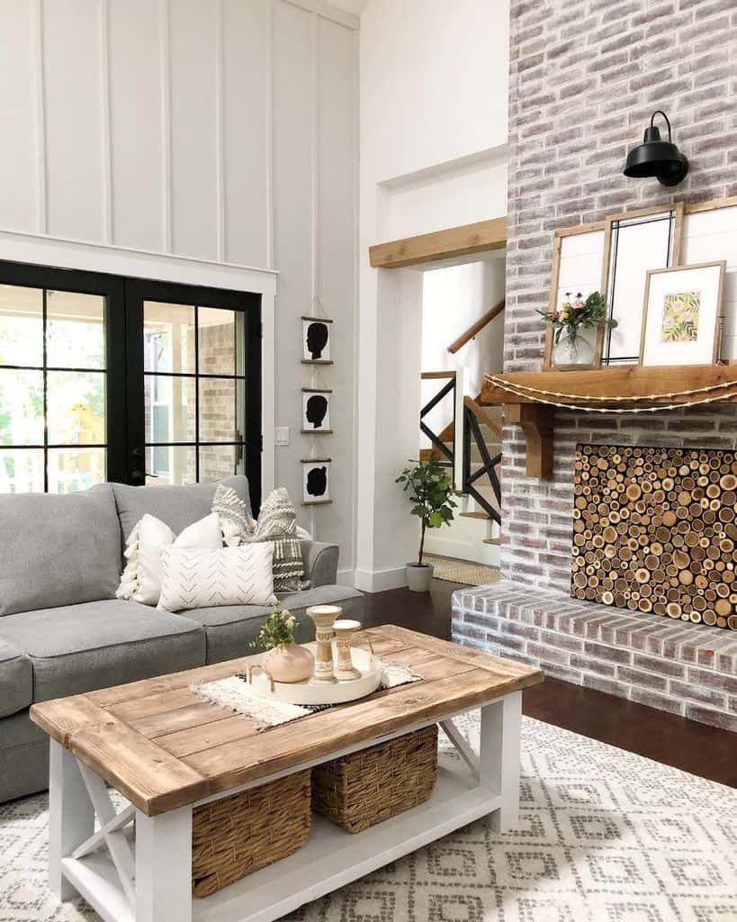 contemporary farmhouse living room brick fireplace gray sofa wood table with wicker baskets