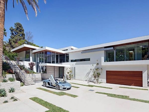 Concrete driveway with grass accents arranged in rectangular patterns.