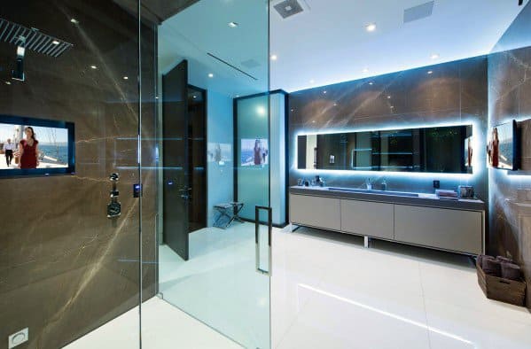 Modern bathroom with LED-lit mirror, glass shower, and sleek minimalist design.