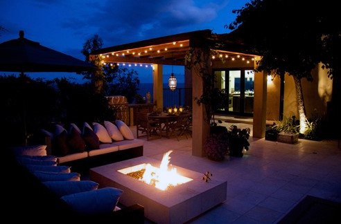 contemporary backyard patio with string lights