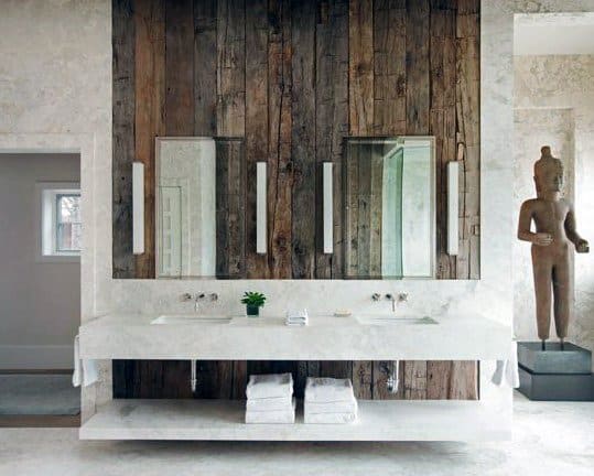 Rustic bathroom with a double sink, wooden walls, and a statue in the corner