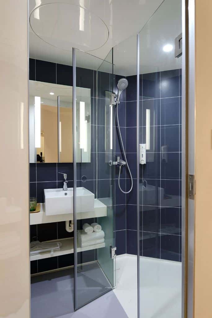 blue tile wall bathroom with shower