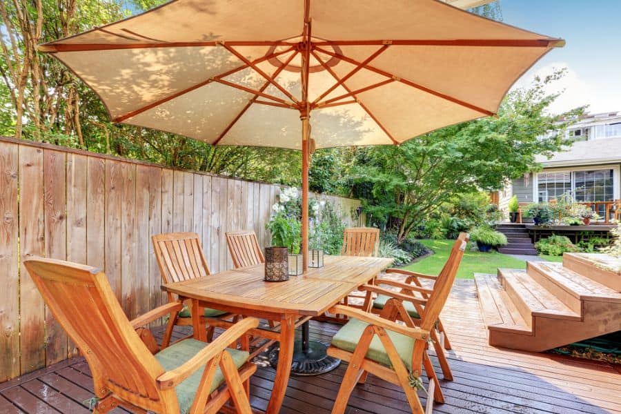 wood deck with umbrella shade and outdoor furniture