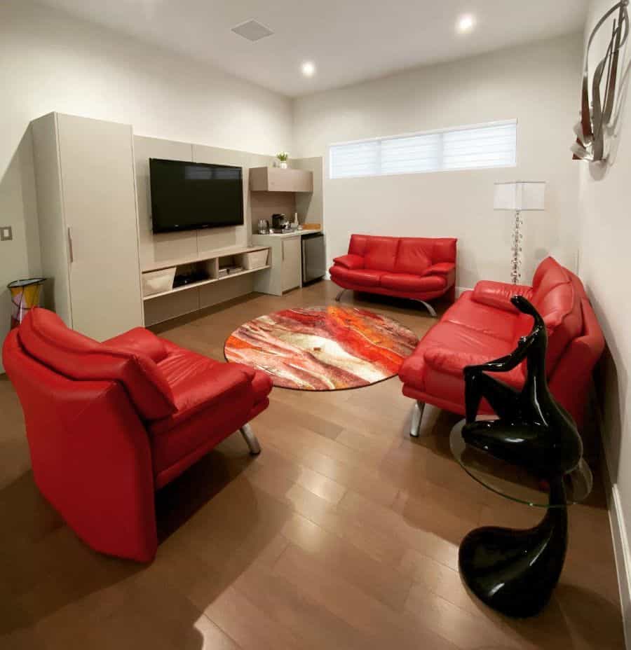 contemporary tv room with red sofas 