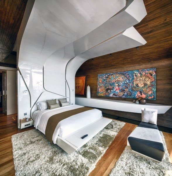Contemporary bedroom with unique ceiling design, artistic wall art, and warm wood accents.